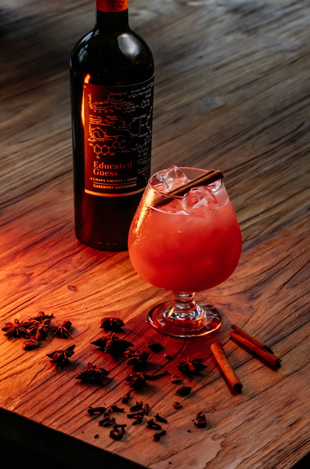 a bottle of wine and a glass of beer on a wooden table